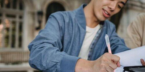 Man writing on paper.