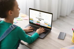 Teen Schoolgirl Using Laptop Computer At Home For Online Education.