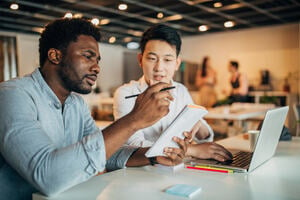 Young multi ethnic-group of people discussing about writing an essay.