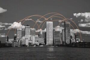 A black and white city skyline with orange lines connecting each building. 