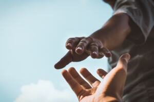 Two hands reaching out to one another.