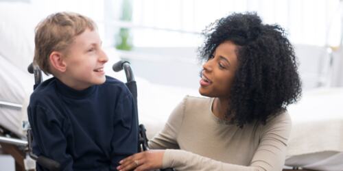 Woman with a young boy in a wheelchair.